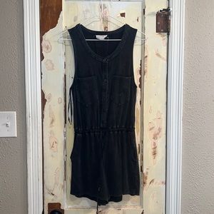 Size small black romper with four pockets. Tights at the waist and buttoned top.